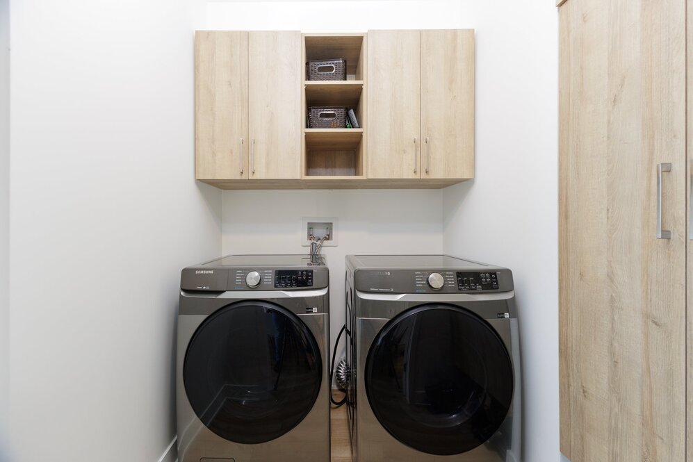 Laundry room - Well appointed laundry room with custom cabinets.